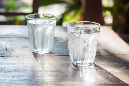 Glasses of cold water on wooden table