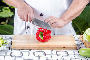 Chef cutting tomato