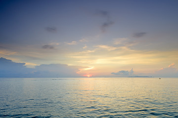 Naklejka na ściany i meble Panoramic dramatic sunset sky and tropical sea at dusk