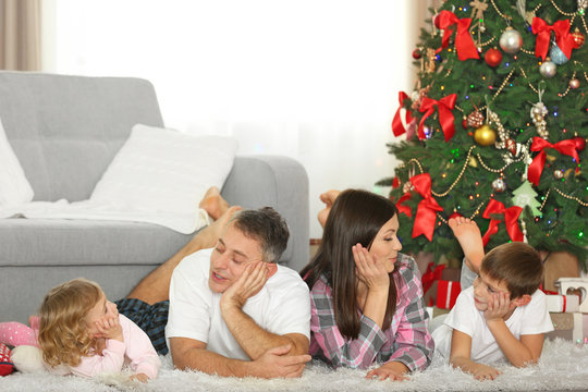 Christmas family portrait in home holiday living room, at morning