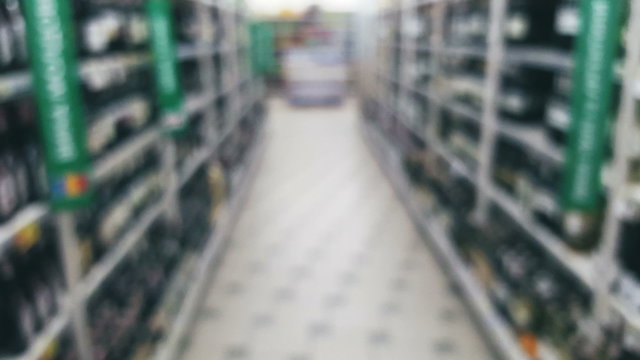 Supermarket store motion people, Liquor department, blur background with bokeh