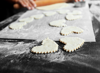 Woman cooking biscuits in kitchen