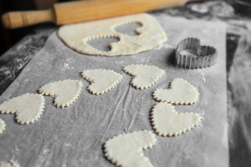 Uncooked heart shaped biscuits on a table