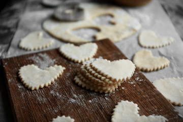 Uncooked heart shaped biscuits on a table