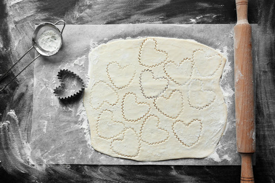 Uncooked heart shaped biscuits on a table