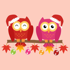 Two owls on maple tree wearing a red santa claus hat with christ