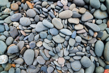 Beach pebbles stones smooth background mixed colorurs and shapes