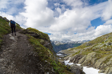 Fototapeta premium Young woman climbing in highland trail