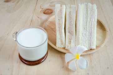 sandwich with milk on wood background