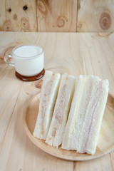 sandwich with milk on wood background