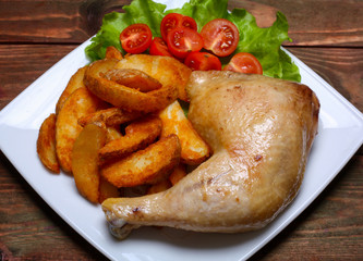 Fried chicken legs with french fries on the table