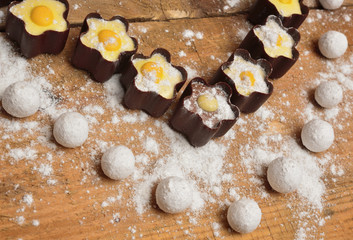 Candy in heart shape on wooden background
