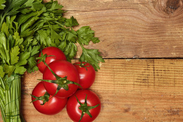 parsley, dill and tomatoes on wooden background