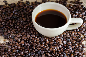 Dark coffee with coffee beans