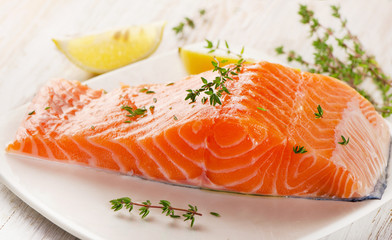 Salmon fillet on a white plate.