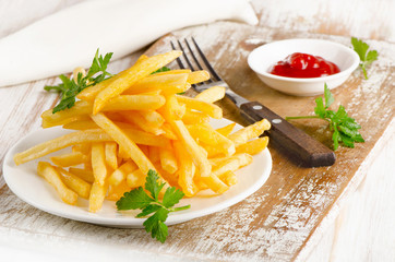 French fries on a wooden board.