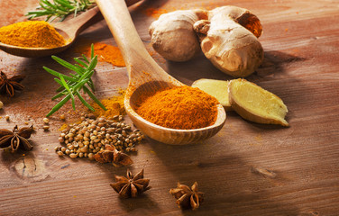 Spices and herbs on a wooden background.