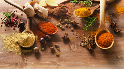 Various spices on a wooden board.