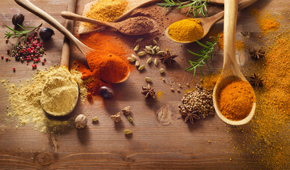 Various spices on wooden board.