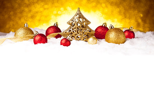 Golden christmas fir tree decoration with gold and red ornaments