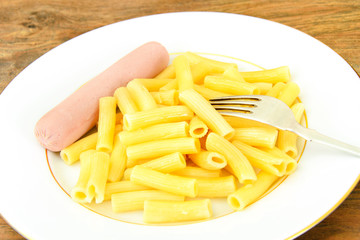Eating Fast Food: Pasta with Sausage on Plate.