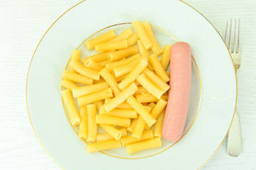 Eating Fast Food: Pasta with Sausage on Plate.