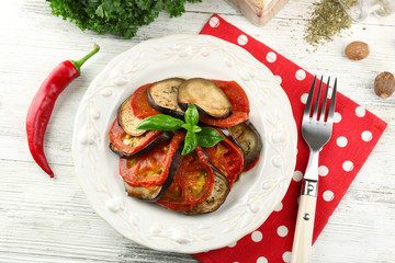 Ratatouille on plate, on table background