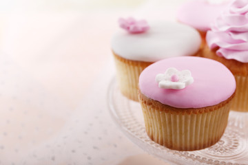 Tasty cupcake on stand, close-up