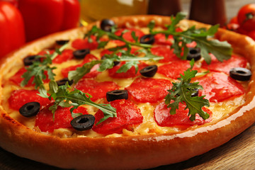 Tasty pizza with salami on decorated wooden table, close up