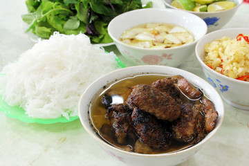 Bun cha, a Vietnamese dish of grilled pork and rice noodles served with fresh herbs and dipping sauce