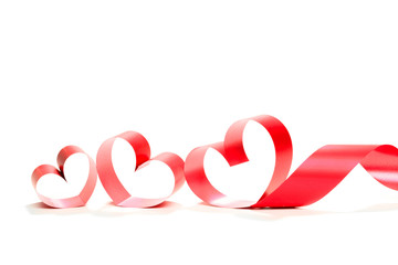 Ribbons shaped as hearts on white