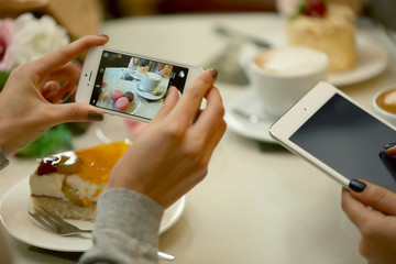 Woman taking photo of food in cafe