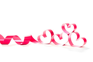 Ribbons shaped as hearts on white