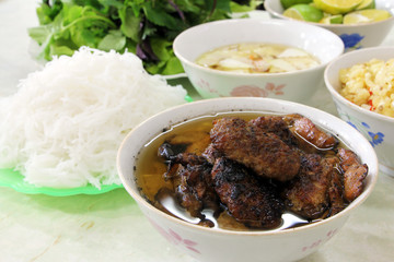 Bun cha, a Vietnamese dish of grilled pork and rice noodles served with fresh herbs and dipping sauce