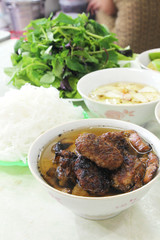 Bun cha, a Vietnamese dish of grilled pork and rice noodles served with fresh herbs and dipping sauce