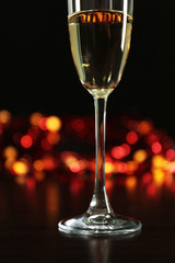 A glass of champagne with bokeh on dark background