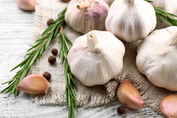 Composition of garlic and rosemary on sacking, close up