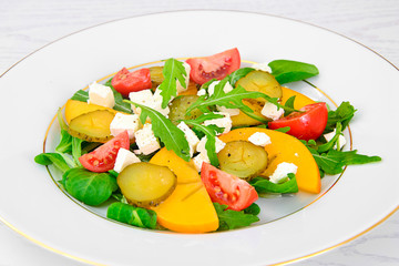 Healthy and Diet Food: Salad, Persimmon, Pickled Cucumber, Tomat