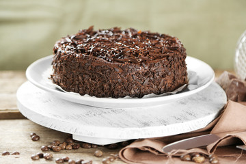 Tasty chocolate cake on wooden background