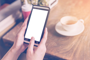 hand woman using smartphone in coffee shop and soft light with v