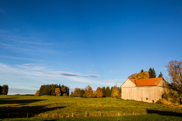 Obraz premium A Hut and Farm with Blue Sky Near Wieskirche - Steingaden, Germa