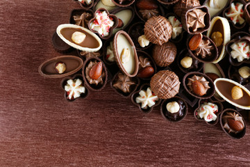 Appetizer chocolate candies on wooden background