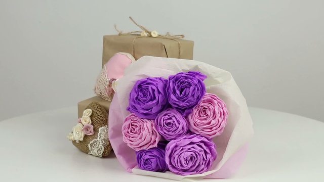 Paper bouquet of roses and gifts