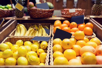 fruits in baskets with nameplates at food market