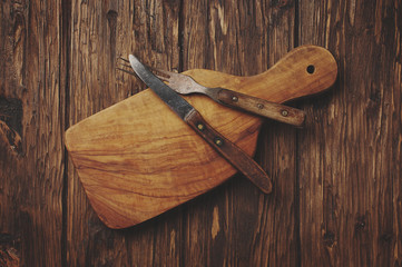 Cutting board on the vintage wooden background