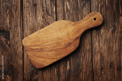“Cutting board on the vintage wooden background” Stock photo and