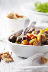 Stewed meat with carrot, paprika and rosemary