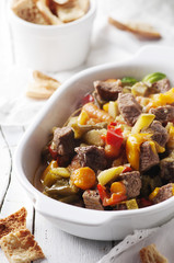 Stewed meat with carrot, paprika and rosemary