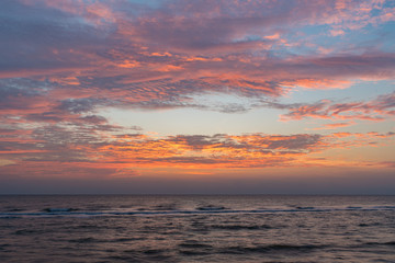 Naklejka na ściany i meble Colorful of sunrise on the ocean beach