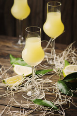 Iralian traditional liqueur with lemons on the vintage table